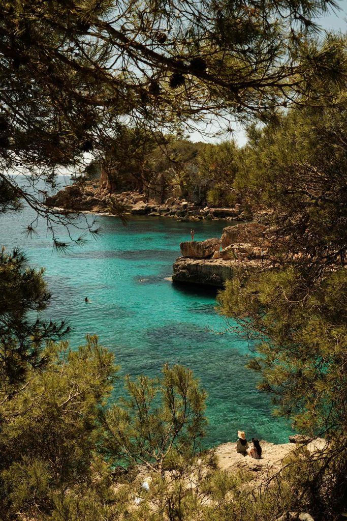 Quiet beauty by the sea. Two women pause above a turquoise